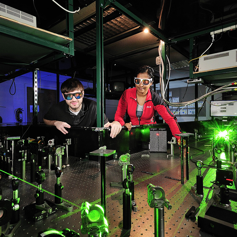 Students performing research in Professor Zhao's laser lab