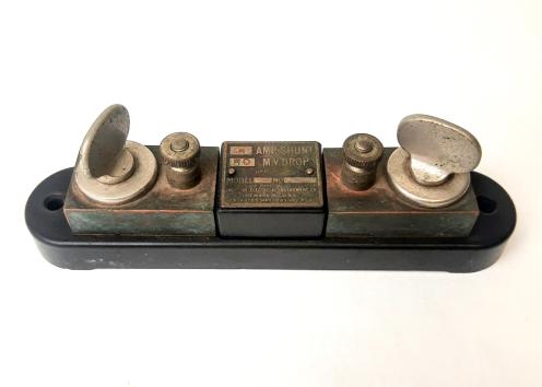 Weston portable and switchboard shunt with 2 adjustable knobs on either side with bolts for connecting wire. Consists of a central label titled "5 AMP SHUNT 50 MV DROP" Along with the name of the company "Weston Electrical Instrument Company".