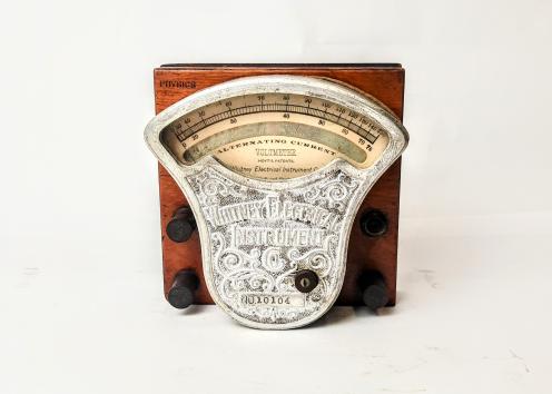 Whitney Instrument Co. AC Voltmeter no. 10104 in silver color mounted on a wooden board.
